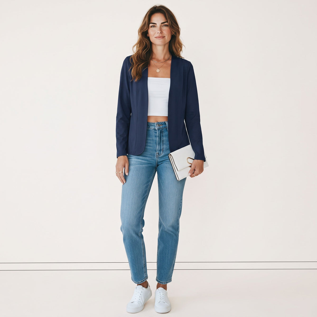 Crisstians fashionstore donkerblauw kraagloos damesvest met slanke pasvorm, gedragen met jeans en witte top.